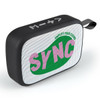 A black portable speaker with mesh design and a colourful logo, featuring a carrying strap.
