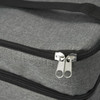 A grey cooler bag with a double zipper and black accents, featuring a sturdy handle.