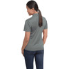 A grey women's polo shirt features a classic design and a logo on the back. The model is wearing jeans.