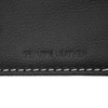 A close-up of a black leather texture featuring embossed text "Genuine Leather" and white stitching.