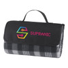 A folded picnic rug in grey and black checkered pattern with a black carrying strap and a logo on the front.