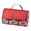A red picnic rug with a plaid design, featuring a black edge and carrying handle, includes a logo.