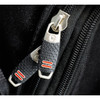Close-up of black zippers with textured grips and red accents on a backpack. Features a sleek, modern design.