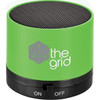 A green cylinder Bluetooth speaker with a mesh top and a logo. It features an on/off switch at the bottom.