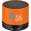 An orange cylinder Bluetooth speaker with a black mesh top and a branded logo on the side.