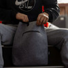 A grey recycled felt cooler tote bag with a zipper pocket, being held by a person wearing casual attire.