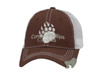 A brown cap with a mesh back featuring a logo on the front. It has a curved brim and an adjustable strap.