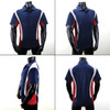 A polo shirt featuring navy blue, red, and white panels, displayed from multiple angles on a mannequin.