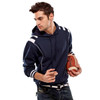 A navy blue hoodie with white stripes, featuring a hood and a front pocket, being held by a man with a rugby ball.