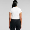 A white T-shirt with short sleeves, viewed from the back, paired with black high-waisted pants.