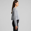 A grey cropped sweater displayed on a model from the side, featuring long sleeves and a relaxed fit.