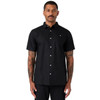 A black short-sleeve button-up shirt worn by a model, featuring a subtle logo.