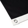 A black canvas flag featuring a white hem and grommet for secure hanging.