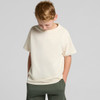 A youth classic tee in cream colour, featuring a relaxed fit and short sleeves. The model stands with hands in pockets.