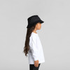 A child in a white long-sleeve tee and a black bucket hat, standing in profile against a neutral background.