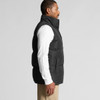 A black puffer vest on a model, featuring a high collar and pocket details, set against a plain background.