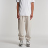 Relax Track Pants in beige, featuring a relaxed fit and elastic cuffs, paired with a plain white t-shirt and sneakers.