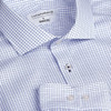 A blue and white check button-up shirt with a collar and a branding label inside.