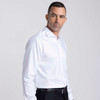 A white button-up shirt on a male model, featuring a collar and a logo. The model wears black trousers.