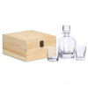 A whisky decanter set featuring a clear glass decanter, two matching glasses, and a wooden storage box.
