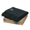 A dark grey Merino blanket with fringe, neatly folded on a brown box. The blanket is made from 100% Merino wool.