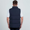 A navy puffa vest viewed from the back, featuring a high collar and a rugged design. It has a branding logo.