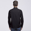 A black button-up shirt viewed from the back, featuring long sleeves and a collar. It has a small logo on the back.