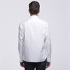 A white button-up shirt viewed from the back, featuring a collar and long sleeves. It has a logo on the back.
