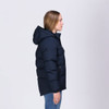 A navy puffer jacket with a hood, featuring a zip and pockets, displayed on a model from the side.