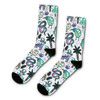 A pair of crew socks featuring a vibrant design with green, purple, and black motifs, including animals and plants.