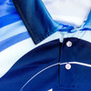 A close-up of a custom fishing polo shirt featuring a blue gradient design and a collar with buttons.