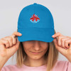 A blue cap with a logo on the front, featuring a curved brim and adjustable back.