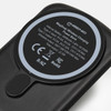A black wireless charging power bank with a circular charging pad and a logo on the surface.