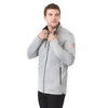A grey men's softshell jacket featuring a zip front and zippered pockets, worn by a model with a logo on the sleeve.