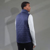 A navy insulated puffer vest with a high collar and lightweight design, worn by a model from the back.