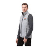 A lightweight, packable insulated puffer vest in light grey, featuring a logo, worn over a long-sleeve grey top.
