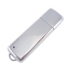 A sleek silver metal flash drive with a smooth surface and a loop for attaching to a keychain.