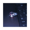 A light bulb flash drive in a clear casing connecting to a laptop, glowing with a red light.