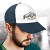 A white and navy trucker cap featuring a logo on the front. The cap has a mesh back for breathability.