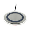 A round silver wireless charger with a black ring around the centre and a connected cable.