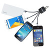 A charging cable in black with multiple connectors attached to three smartphones, including a white power bank.