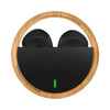 Eco-friendly black earbuds housed in a circular bamboo case with a green indicator light.