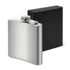A silver hip flask with a screw top, displayed alongside a black box. It features a logo on the flask.