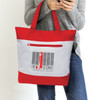 A red and grey tote bag with a zippered pocket and a logo on the front, held by a person using a phone.