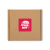 A brown cardboard box with a red label featuring a logo for "Wild Hut Resto Bar."