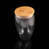 A drink bottle with a clear glass body and a natural bamboo lid, designed for stylish beverage storage.