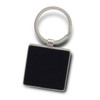 A square black key ring with a silver metal attachment. The key ring features a smooth, textured surface.