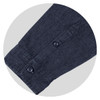 A navy denim button-up shirt featuring a buttoned cuff and a subtle texture, complete with a logo.