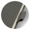 A grey notebook with a textured cover and an elastic closure strap, featuring a branding logo.