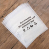 A stack of clear, eco-friendly, biodegradable self-adhesive bags with a logo. The bags have a smooth surface and are lightweight.